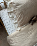 Vintage Rose sheet set close up in soft cotton muslin featuring romantic floral print in soft blush and cream tones, and vintage-inspired charm for dreamy bedrooms.