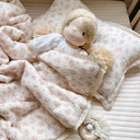 Adeline children's quilt set featuring delicate blush floral print