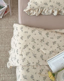 Close-up of the Bluebell quilt showing soft cotton muslin fabric and delicate blue floral details.