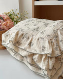 Folded Bluebell quilt set showcasing heirloom-inspired floral bedding in soft blue tones.
