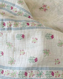 Little House on the Prairie close up on blanket print featuring delicate florals, soft cotton muslin, and timeless storybook charm.