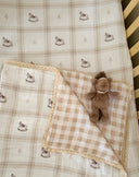 Rocking Around cot bedding bundle with fitted cot sheet and reversible blanket featuring hand-painted rocking horse illustrations by Moon & Back Collective