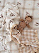 Rocking Around cotton fitted cot sheet featuring hand-painted rocking horse illustrations in warm neutral tones by Moon & Back Collective.